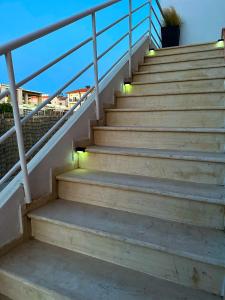 a set of stairs with lights on them at Asteria Apartments in Analipsi