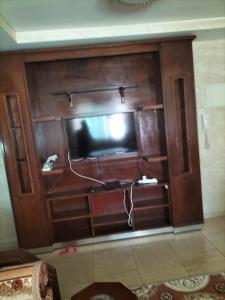 a large wooden entertainment center with a flat screen tv at Résidence alhouda in Agadir
