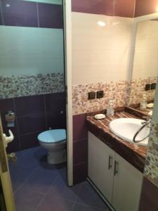 a bathroom with a toilet and a sink at Résidence alhouda in Agadir