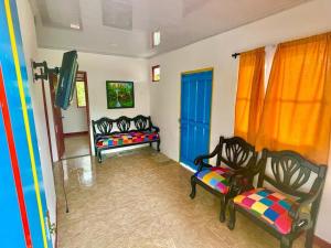 a living room with two benches and a blue door at VILLA SOFIA in Montenegro