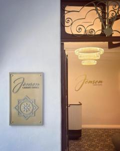 a room with a sign on the wall and a chandelier at Jensen Luxury Suites in Rhodes Town