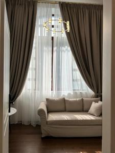 a living room with a couch in front of a window at Jensen Luxury Suites in Rhodes Town +89 photos