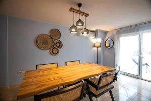 a dining room with a wooden table and chairs at Maisonette PT in Perea