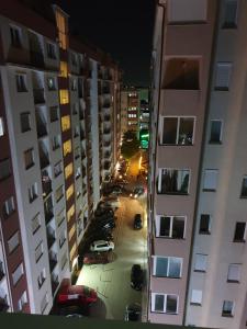a view of a street between buildings at night at Budget Stay Guest House in Kosovo Polje