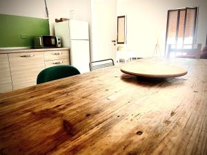 a wooden table with a wooden bowl on top of it at Country House Nora Rech in SantʼElpidio a Mare