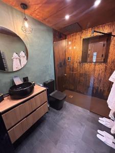 a bathroom with a sink and a mirror at La Tentacion de Mazobre - La Suite de la Montaña Palentina in Alba de los Cardaños