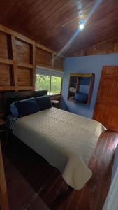 um quarto com uma cama grande numa casa em Cozy Woodcabin em Santa María