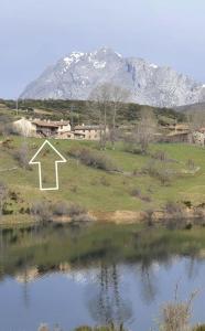 a view of a mountain with a lake in front of it at La Tentacion de Mazobre - La Suite de la Montaña Palentina in Alba de los Cardaños