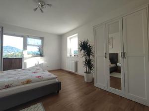 a bedroom with a bed and a sliding glass door at Ferienwohnung Großalber in Maria Neustift