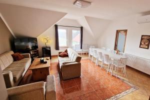 a living room with a long table and chairs at The Luxo Wine Museum Hotel in Kaba