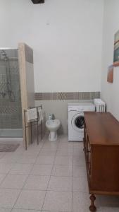 bagno con lavandino e servizi igienici e lavatrice. di L'Iris a Livorno