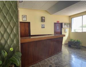 a waiting room with a reception desk in a building at ApartBeach Wyliana in Candelaria
