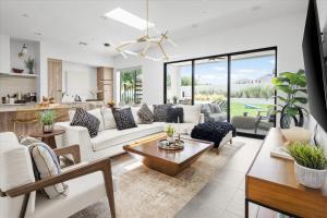 a living room with white furniture and a kitchen at Horizon Heights in Scottsdale