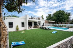 a house with a large yard with a swimming pool at Horizon Heights in Scottsdale