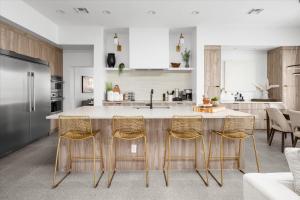 a kitchen with a counter with chairs around it at Horizon Heights in Scottsdale