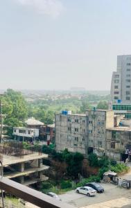 a city with cars parked in a parking lot at Islamabad Holiday Appartments One & Two Bed A Perfect Winter Escape to Murree, Northern Areas & Beyond in Islamabad