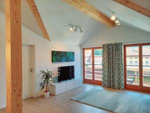 a living room with a flat screen tv in a room at Ferienwohnung Menter in Marquartstein