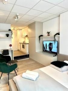 a living room with a tv on a wall at Heart of Grand Place Beautiful Studio in Brussels