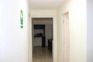 a hallway leading to a room with a kitchen at Hospedaje San Isidro 402 in Lima