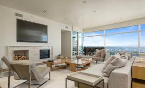 a living room with a fireplace and a tv at Luxury apartments in Los Angeles