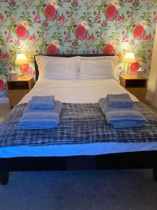 a bedroom with a bed with two pillows on it at Coniston House Lancaster 3 bedrooms Parking and Garden in Lancaster