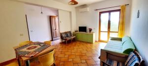 a living room with a couch and a table at Taormina al mare Villetta in Mazzeo