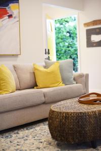 a living room with a couch and a table at Mile to Beach! Fully Fenced Private SoCal Cottage in Oceanside