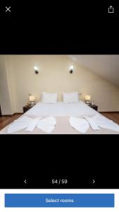 a bedroom with a large bed with white sheets and pillows at pialo in Paposhvilebi