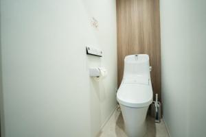a bathroom with a white toilet in a stall at 貸切アパートメントSign Palace サインパレス in Kagoshima