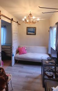 ein Wohnzimmer mit einem Bett und einem Kronleuchter in der Unterkunft Karu-Terra cabin in Huiscapi