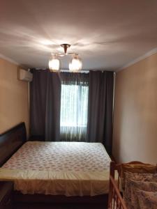 a bedroom with a bed and a window at Apartment on Abazgaa 53-4 in Gagra