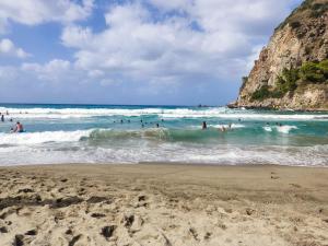 a group of people in the water at the beach at Holiday Home Ischia in Ischia Town