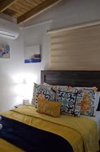 a bedroom with a bed with pillows on it at Casita Playera Aguadeña 