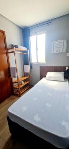 a bedroom with a bed and a bunk bed at Hotel Platina in Juiz de Fora