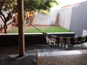 a hammock tied to a pole in a courtyard at Pousada do Julio in Barretos
