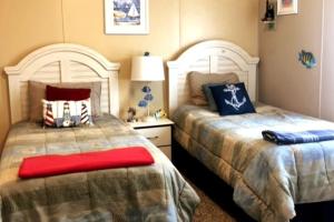 two beds sitting next to each other in a bedroom at Palm Key Oasis - Close to Attractions in Davenport +45 photos