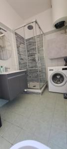 a bathroom with a shower and a washing machine at Casa Anna appartamento fronte mare Ventimiglia in Ventimiglia +38 photos