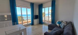 a living room with a couch and views of the ocean at Casa Anna appartamento fronte mare Ventimiglia in Ventimiglia