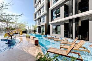 a row of chairs sitting next to a building at Soi 7 Hua Hin - Ji Ya in Hua Hin