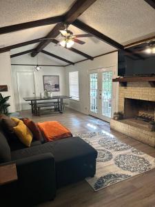 a living room with a couch and a fireplace at 10 Min to Sea World & Lackland, Pets OK, Sleeps 12 in San Antonio