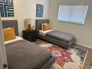 a bedroom with two beds and a rug at 10 Min to Sea World & Lackland, Pets OK, Sleeps 12 in San Antonio
