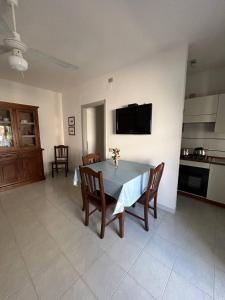 a kitchen and dining room with a table and chairs at PM 15 Via Liguria Guest House in Alghero