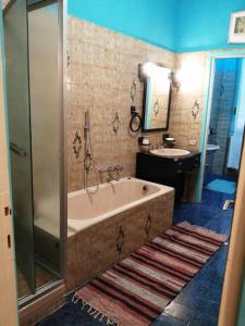 a bathroom with a bath tub and a sink at Il grande blu in Milan