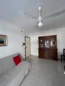 a living room with a couch and a ceiling fan at PM 15 Via Liguria Guest House in Alghero
