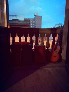 una chitarra seduta sul cornicione di un balcone di Casa Copada a Montevideo