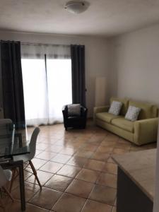 a living room with a couch and a chair at Monis Hogar in Arzachena