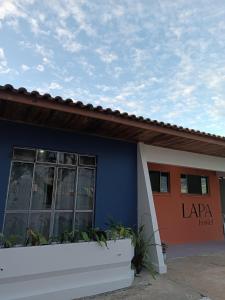 a blue and orange building with a sign on it at Lapa Hostel - PARANÁ in Lapa