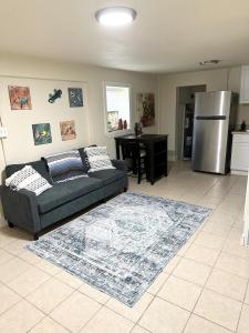 a living room with a couch and a refrigerator at Minutes to the River Walk and the Alamo Pet Friendly Sleeps 8! in San Antonio