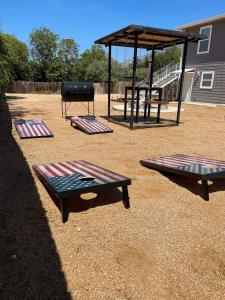three picnic tables and a gazebo in a yard at Minutes to the River Walk and the Alamo Pet Friendly Sleeps 8! in San Antonio