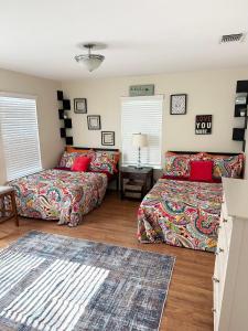 a living room with two beds and a table at Minutes to Riverwalk, Sleeps 12, Pets Welcome! in San Antonio